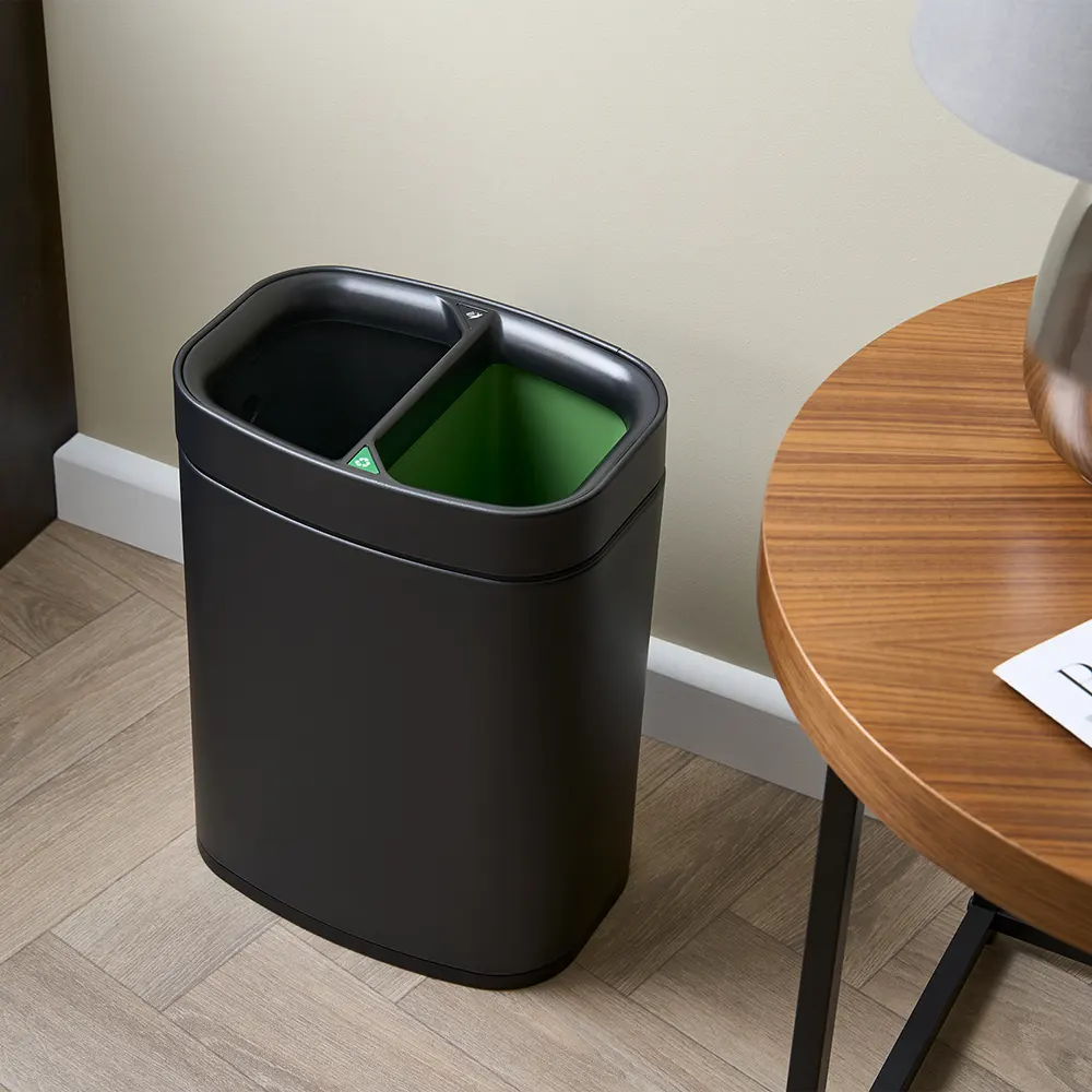 eb6ede_464ce23717bd405b8f7f233f1bebd1d5~mv2 NEWPORT 12L dual recycling bin – brushed steel, angled view in guestroom