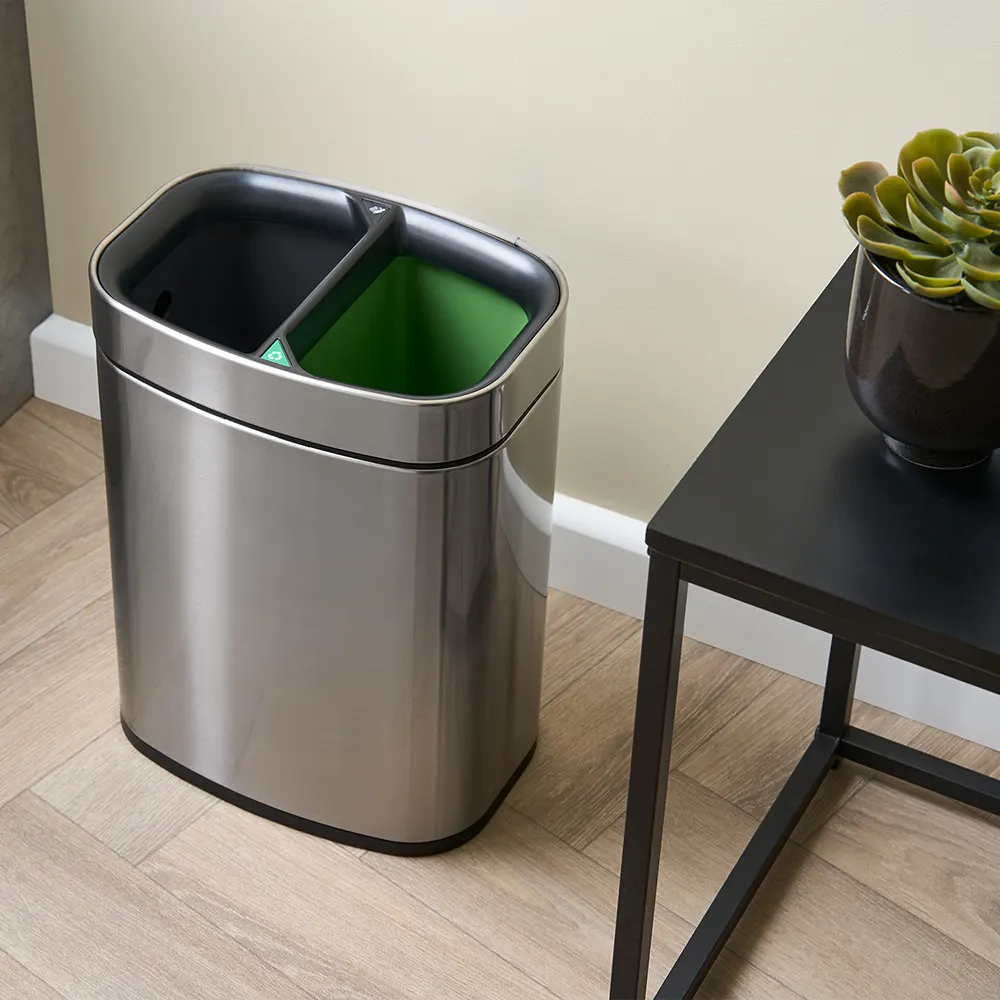 eb6ede_8e15e001f7a647fdb3eaf150cd351026~mv2 NEWPORT 12L dual recycling bin – brushed steel, angled view in guestroom