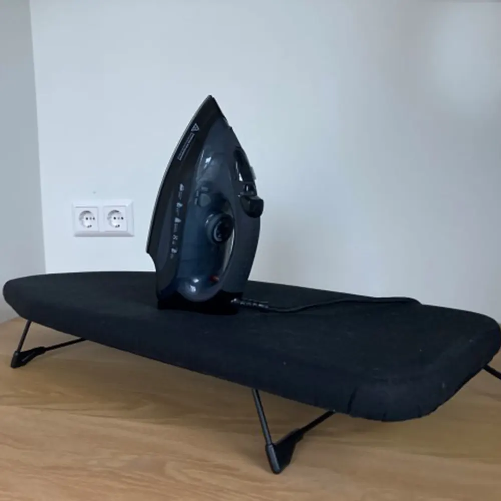 MINI tabletop ironing board for hotel rooms with iron in use